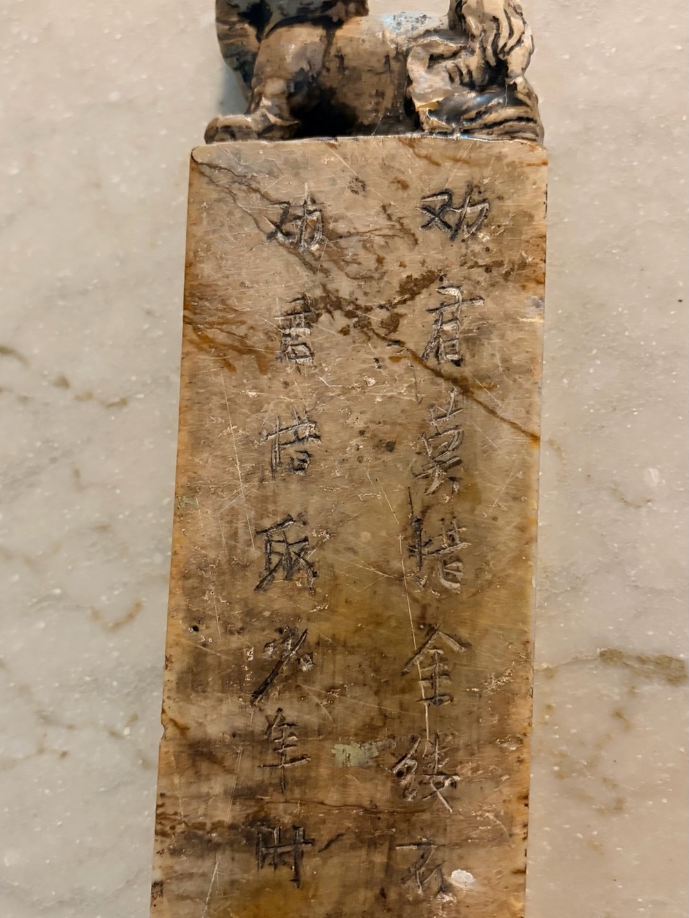 Hand-Carved Beige Stone Sculpture with Engraved Script